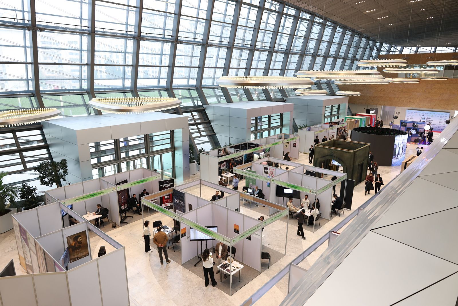 Bright exhibition hall with booths and visitors at a trade show, like a real cruise travel expo
