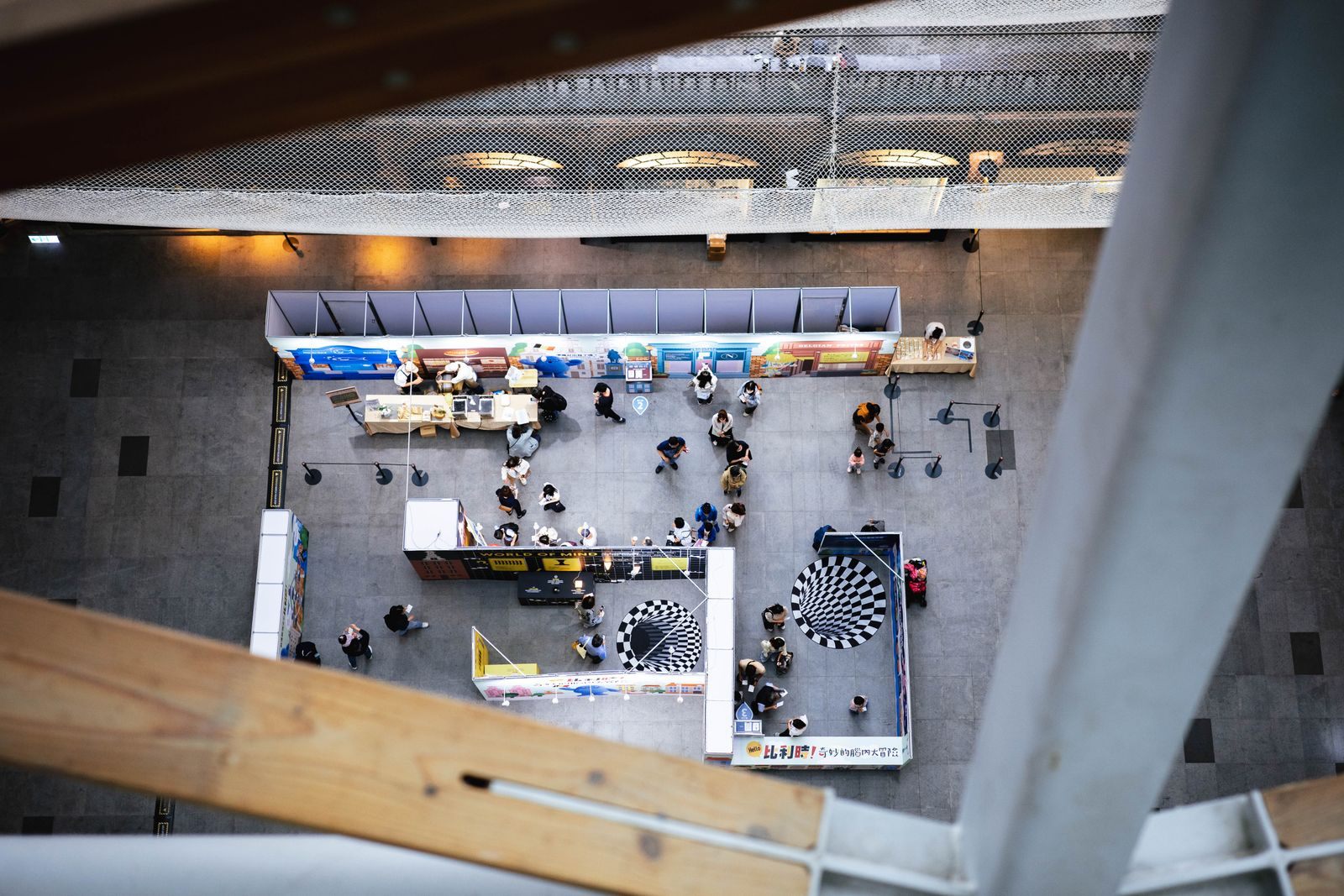 Overhead view of exhibitor stands and visitors on a busy expo floor